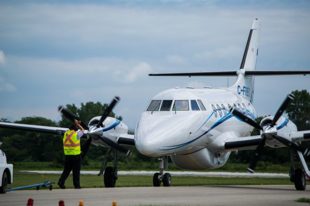 British Aerospace Jetstream 31 (C-FREQ) - C-FREQ, a Jetstream 31 is parked on the taxiway so it can be towed past the parked B-17.