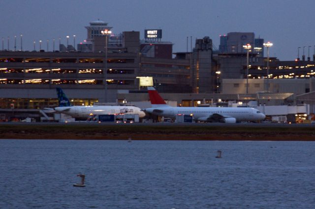 Airbus A320 (HB-IJS) - Swiss A320 at BOS next to Jet Blue at first light on 12/2/21. Plane departed later that morning for Pinal Air Park (MZJ) probably to be retired.