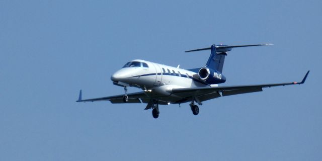 Embraer Phenom 300 (N14AQ) - About to touch down is this 2012 Embraer Phenom 300 in the Summer of 2024.