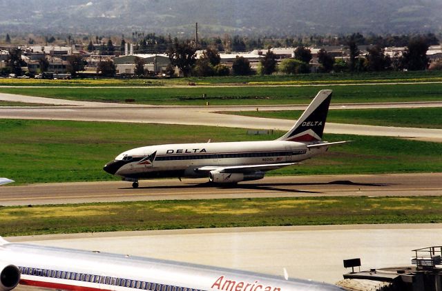 Boeing 737-200 (N321DL) - KSJC- arriving from KSLC - this 737 200 idles past the newer Terminal A in this early 1990 s photo on it s way to the old Terminal C - now gone. Most of this view was blocked by the new Customs building built years later.