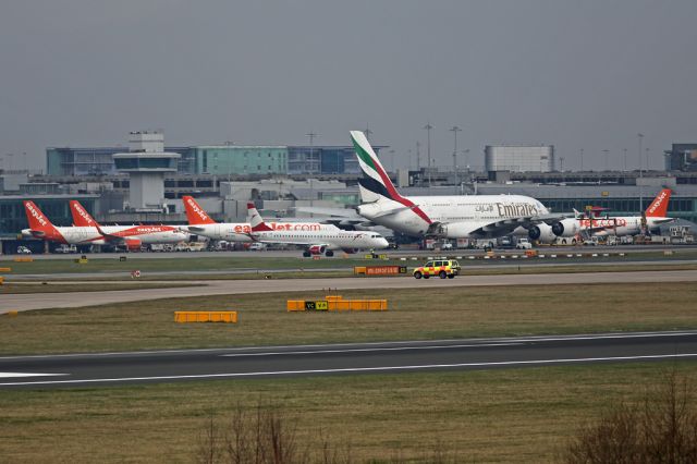 Embraer ERJ-190 (OE-LWI) - OE-LWI taxying for departure as the Emirates A380 dominates the scene with a collection of EZY Airbuses and a Helvetic F100.  Photo taken from "Radar Hill" behind the 23L/05R fire station