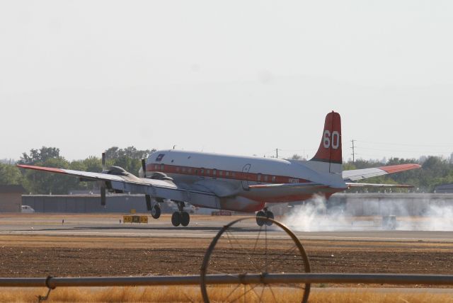 Douglas DC-7 (N838D) - KRDD - DC-7B N838D of Erickson Aero Tankers landing at Redding during the Boles Fire Sept 2014. This Air tanker saved the day on the Boles fire making many critical Phos-chek drops to quell the fast moving fire started by an idiot in Weed,CA. Hit full for large image.