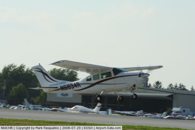 Cessna T210 Turbo Centurion (N6834R) - Departing the Oshkosh air show.