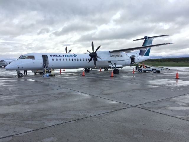 de Havilland Dash 8-400 (C-GKWE) - West Jet Encore being serviced in Summer 2018 on a rainy day!