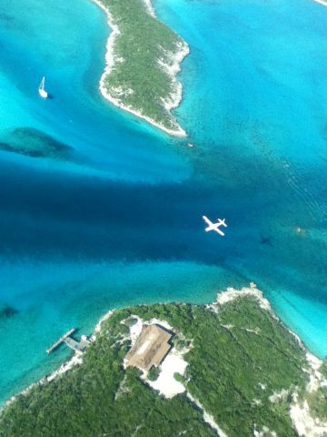 Cessna Caravan (WMA123) - Watermakers Air Flight 123 Landing at Staniel Cay, (Exhuma Bahamas). The former "Club Thunderball" can be seen below.