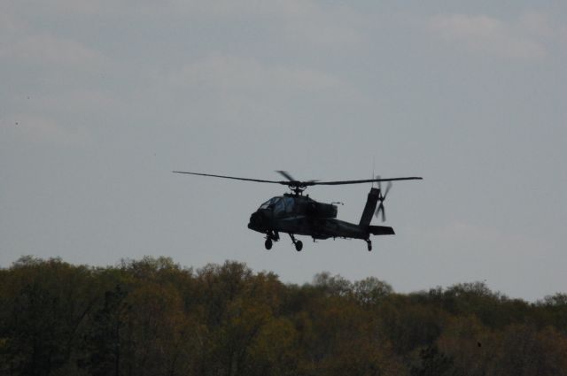 — — - AH-64D taking off from CXO.