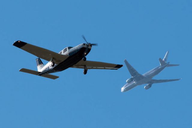 Piper Saratoga/Lance (N296HP) - 3/24/12:  P32R N296HP over Miami Lakes enroute to runway 9L at Opa-locka Executive Airport as American Airlines B777-223ER N754AN passes in the background enroute to Miami International Airport.