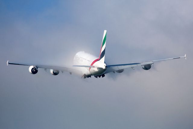 Airbus A380-800 (A6-EEB) - UAE18 disappearing into the remains of the mornings fog after departing Manchester on 23L