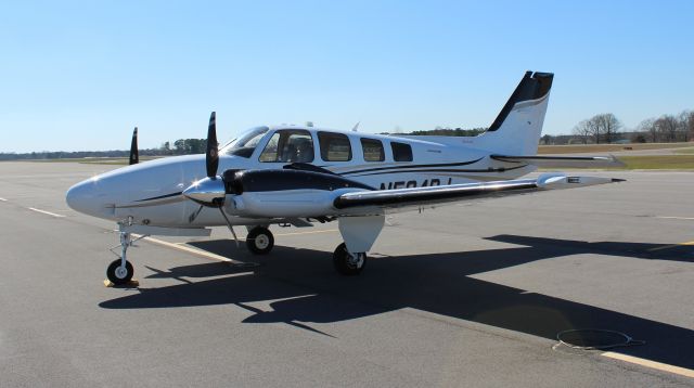 Beechcraft Baron (58) (N584RJ) - A Beechcraft G58 Baron on the ramp at Thomas J. Brumlik Field, Albertville Regional Airport, AL - March 10, 2017.  I realize this is the "shaded" side of the aircraft, but  I love the sun sparkle effects...