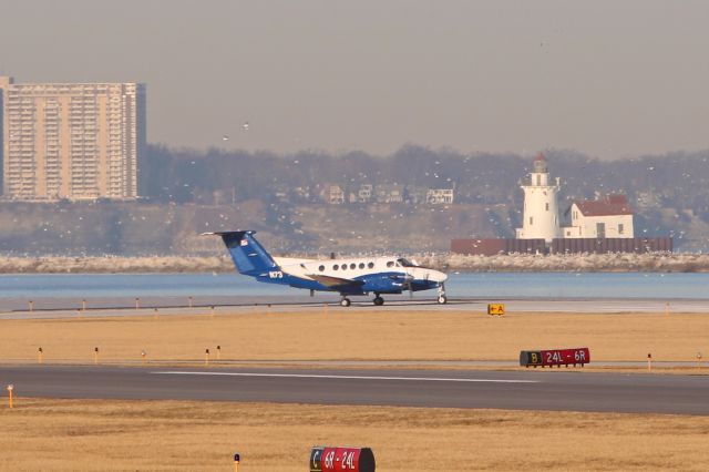 Beechcraft Super King Air 300 (N73) - Flight Check 73 ready for an early morning departure on RWY 6L amidst a scenic Cleveland/Lake Erie backdrop on 27 Mar 2019.