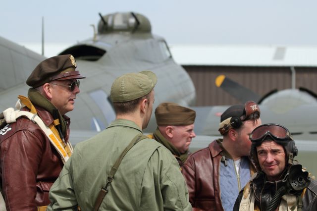 — — - Volunteers dress up in the uniform of a B-17 Bomber Crew, here seen in front of the "Memphis Belle" B-17 Flying Fortress at Duxford Air Museum.