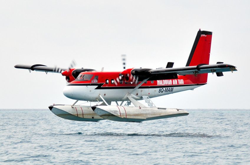 De Havilland Canada Twin Otter (8Q-MAM) - 2006 - Ellaidhoo Is., Seaplane approaching to land in rain storm