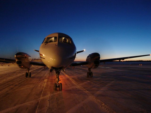 C-GXPS — - Twilight deepens as Corporate Express Airlines arrives from Calgary International Airport at Fort McMurray, Alberta, Canada