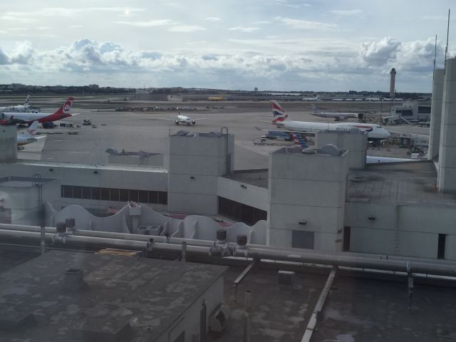 Boeing 747-400 (G-CIVB) - Busy New Years Day between Concourses E and F at KMIA. From left to right: Finnair A330-300, AirBerlin A330-200, Surinam Airways 737-300, US Airways A320, British Airways 747-400. 