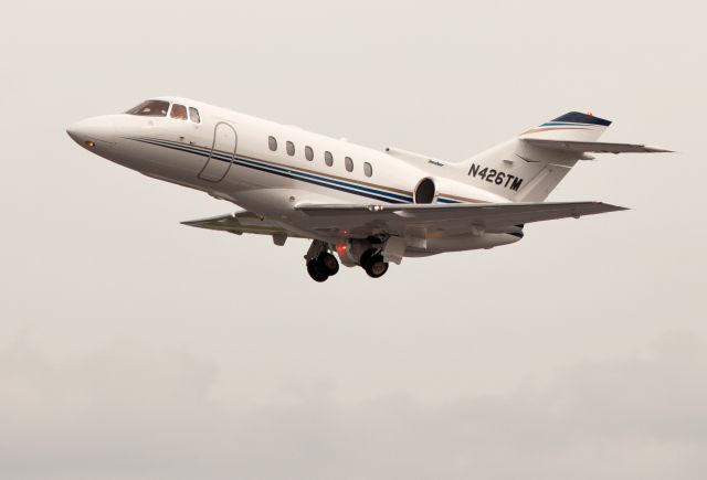 Hawker 800 (N426TM) - Take off RW26. Nose gear retracts first in the up cycle.