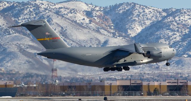 05-5143 — - A light covering of snow on the Virginia Range Mountains east of the airport creates a cool backdrop to this first gallery shot of 05-5143, a C-17A Globemaster III, completing its s/final approach to Reno Tahoe Internationals runway 16L.