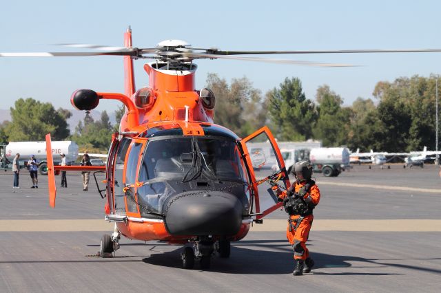 — — - The crew from US Coast Guard station San Francisco preps the HH-65 Dolphin for departure.