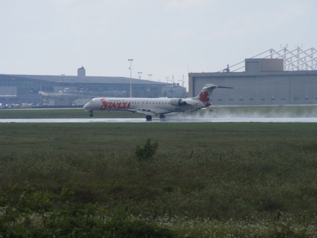 Canadair Challenger (C-FNJZ) - landing just after a rain shower on runway 25.