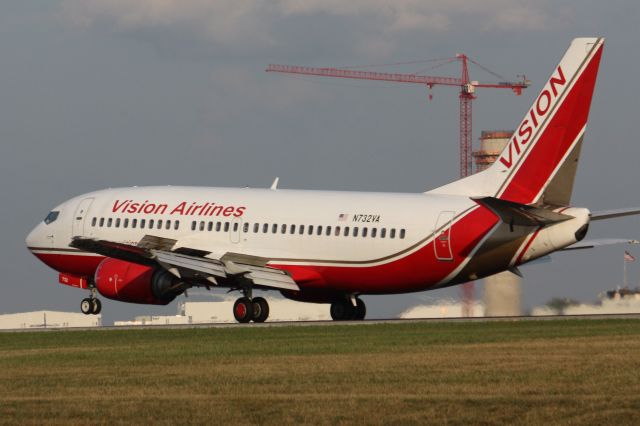 Boeing 737-700 (N732VA) - Vision 737 touching down with the new tower in the background