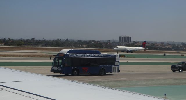 Embraer 170/175 (N614CZ) - Delta bird on take off roll as the Delat bus rolls by