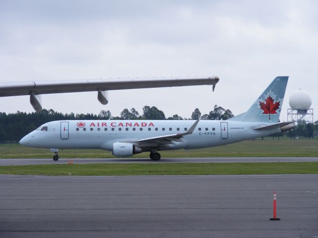 C-FFYG — - Fedex wing in fore ground as embraer 175 taxis towards runway #25