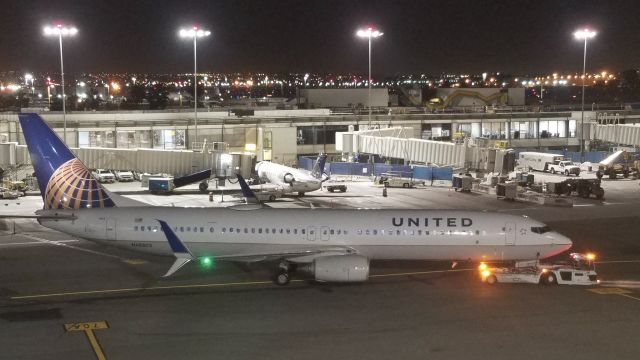 Boeing 737-900 (N68802) - On the tug - shot from the DAL lounge.