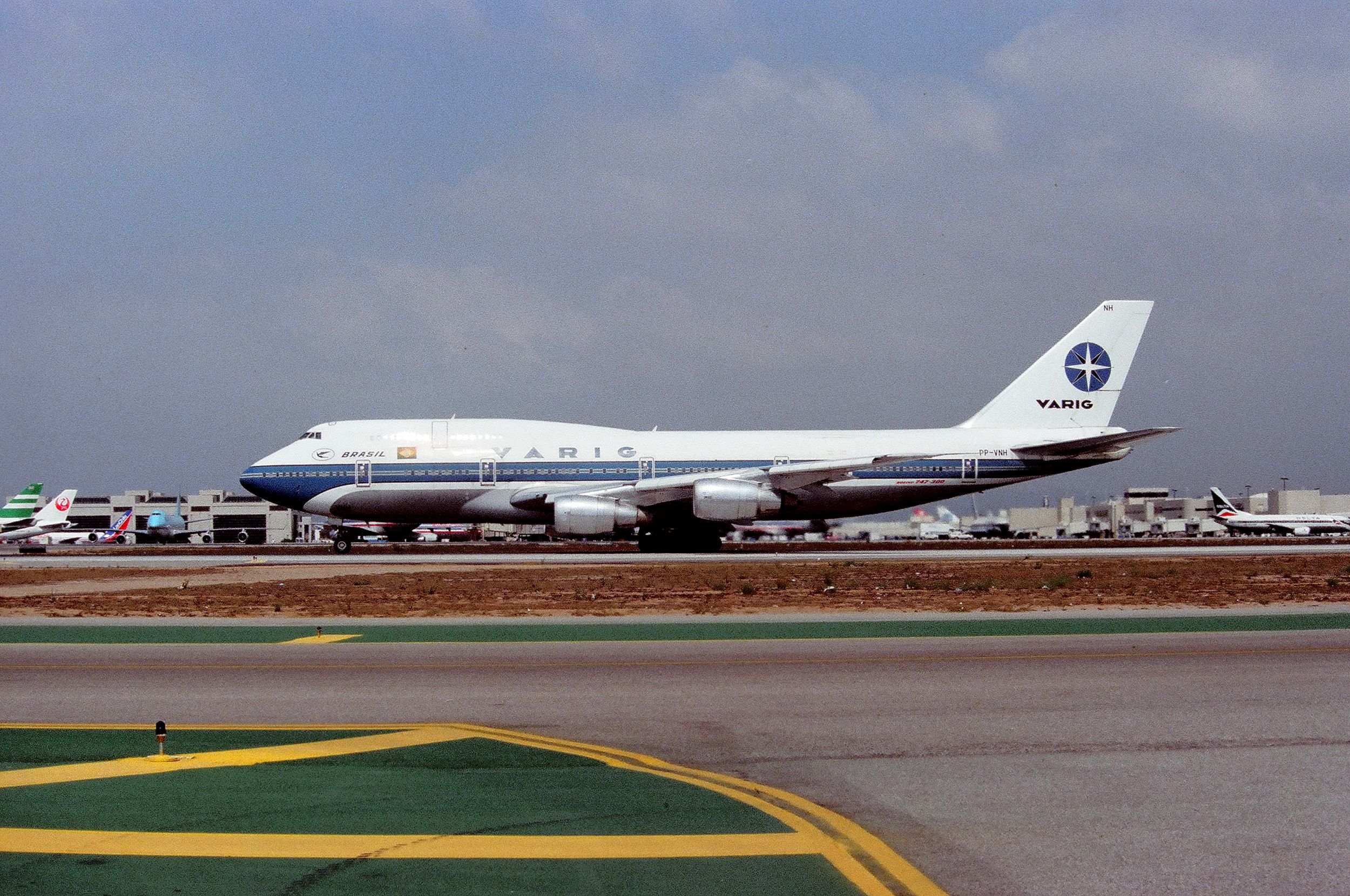 BOEING 747-300 (PP-VNH) - KLAX - March 1989 or 1990 - VARIG Boeing 747-3 series - one of my few trips to the LAX airline collectible show - the old Imperial terminal was still open and one could park here all day and photograph one airliner after another arriving LAX - I brought a small ladder as the fence was only 6ft tall. Note the mix of airlines at the Intl dock - and the tail of a Pan Am 747 on the right background!br /br /Serial number 23394 LN:627br /Type 747-341Fbr /First flight date 22/11/1985br /br /click full