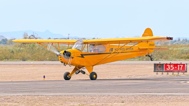 Piper NE Cub (N35547) - At the 2023 Buckeye Air Fair the brisk wind on Friday allows Eric Tucker to land a Piper J3C-65 on a taxiway