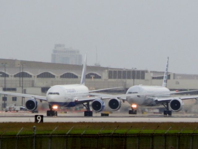 Boeing 777-200 (EI-UNW) - Follow the leader! AAL B777-300-ER Reg#N729AN;;IN background!