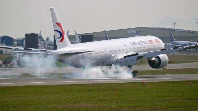 BOEING 777-300 (B-2020) - BOE455 makes tire smoke on landing Rwy 16R to complete its B1 flight on 3/6/15. (ln 1285 / cn 43272).