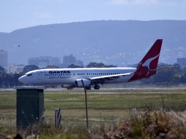 Boeing 737-800 (VH-VYE) - On taxi-way heading for Terminal 1, after landing on runway 23.