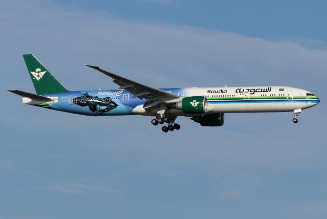 BOEING 777-300 (HZ-AK43) - 'Saudia 023' arriving from Riyadh King Khalid International Airport, Saudi Arabia.SAUDIA Ad-Diriyah E-Prix livery design marks it's long-term partnership with the ABB FIA Formula E Championship. Te all-electric series takes place on December 15, 2024 for the first time in the Kingdom of Saudi Arabia.