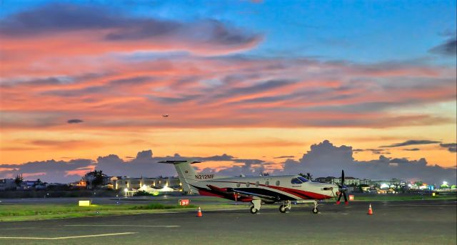 Pilatus PC-12 (N212MF) - Pilatus 12 N212MF resting at TNCM St Maarten for the evening in a Caribbean sunset.