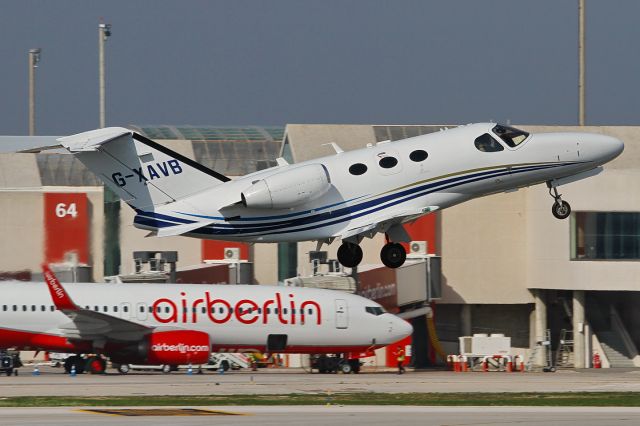 Cessna Citation Mustang (G-XAVB) - date: 18-Feb-2015; with a strong headwind (appr. 20kts from NE) the small jet climbs away from RWY06R like a kite