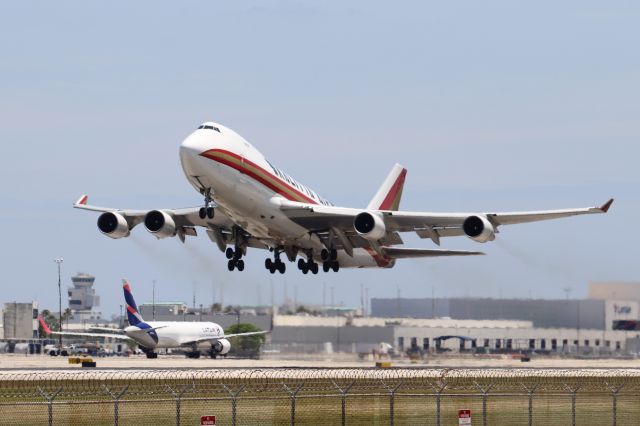 Boeing 747-400 (N710CK) - Miami (MIA). Kalitta Air flight K4539 climbs away from runway 27 departing for Santiago Arturo Merino Benítez (SCL). br /Taken from El Dorado Furniture Store, NW 72nd Avenue adjacent to runway 27/09 south of the airfieldbr /br /https://alphayankee.smugmug.com/Airlines-and-Airliners-Portfolio/Airlines/AmericasAirlines/Kalitta-Air-K4/br /br /2021 05 01