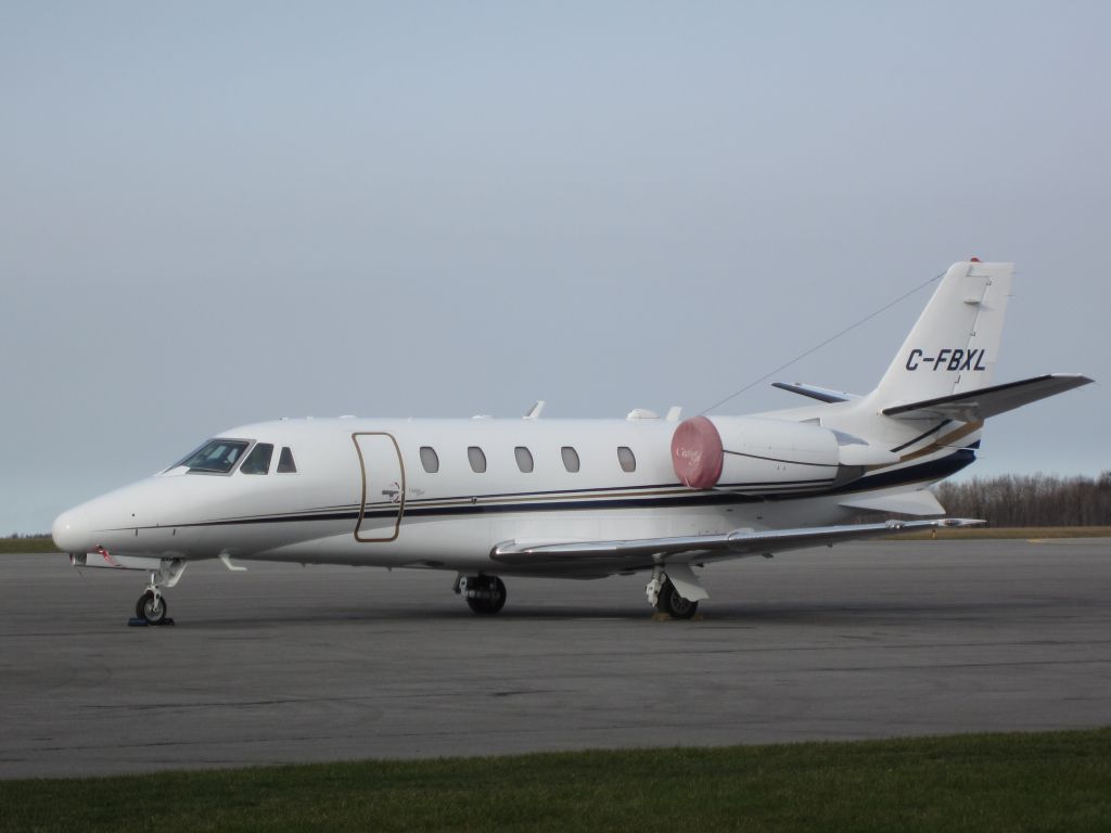 Cessna Citation Excel/XLS (C-FBXL) - Nice Airsprint jet sitting on the tarmac at Kingston.  The intake covers do seem a bit faded though