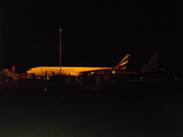 BOEING 777-300 (A6-ECG) - Echo-Charlie-Golf sitting at the international after diverting to OOL due to bad weather in Brisbane.It departed later to YBBN. (Second 77W to ever visit OOL).