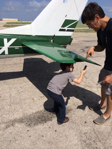 Cessna Commuter (N3213X) - Tristan helping Hangar Mike preflight the Cessna - Fathers Day 2014 KFTW