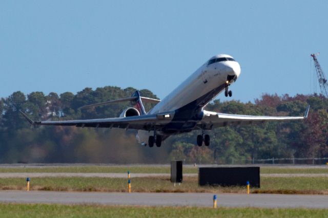 Canadair Regional Jet CRJ-900 (N319PQ) - Blasting off runway 23 in the mid morning light, 11/05/2022.