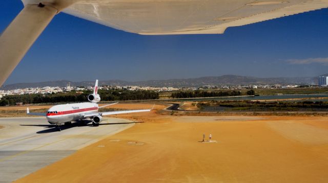 Boeing MD-11 (PH-MCT) - 2002 - Approach to Faro Martinair MD-11 Waiting: How Funny. ATC asked if they were ready to TO, some time before. They were not... br /So they had to wait after for a 2 seater Cessna... br /...silly...