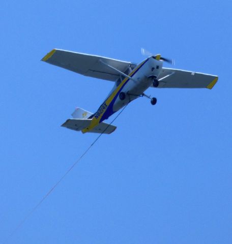 Cessna Skyhawk (N8214X) - Making a low pass is this 1961 Cessna Skyhawk 172B rigged for tow plane operation in the Summer of 2019.