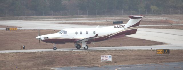 Pilatus PC-12 (N327JZ) - After landing on 02R, taxi to terminal, waiting on clearance.