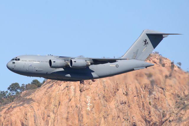 Boeing Globemaster III (A41211) - An RAAF Boeing C-17 Globemaster, performs a flypast over the Strand as part of VP70, Victory in the Pacific Service held at Anzac Park. In the background is Castle Hill. The graffiti on the rock face is the Saint.