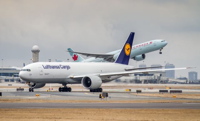 Boeing 777-200 (D-ALFE) - C-FITW lifts off runway 33R at YYZ heading to Japan as Lufty Cargo lines up for runway 23