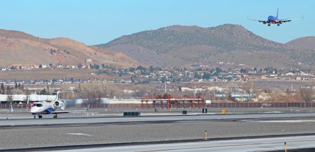 Learjet 60 (N901PM) - Going and coming. A Learjet (N901PM) is approaching rotation speed on 16L as a Southwest is on short final to the parallel runway 16R.