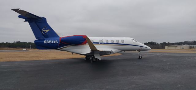 Embraer Phenom 300 (N361AS) - On the tarmac outside the FBO.