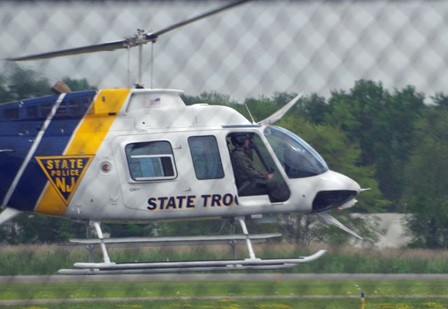 Bell JetRanger (N2NJ) - MORRISTOWN, NEW JERSEY, USA-JULY 24, 2020: A New Jersey State Police Helicopter, registration number N2NJ, is seen moments before landing at Morristown Municipal Airport. The NJSP will help provide security for the arrival, in several hours, of President Trump on board Air Force One. Because of the increased security prior to the arrival, no one was allowed to get close to the fence line.