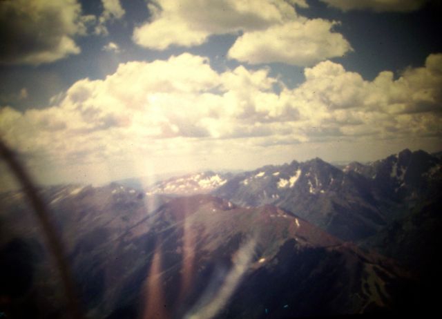 — — - Soaring above the peaks of the Rockies. August 1980