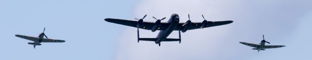 — — - RAF Battle of Britain Flight" at Jersey Air Show Aug 3, 2016 - not best image taken from approx 1.5 miles with Canon 300mm + 2xconverter to make 600mm lens - image stopped at 1/2500 sec, so with  distance image grainy also props stopped not ideal - but hopefully atmosphere retained with Hurricane, Lancaster and Spitfire making up the formation, always the crowds favorites along with the Red Arrows