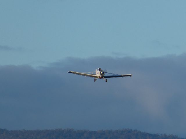 — — - Cropduster overflying Launceston, after conducting spraying operations to the east of the aerodrome.